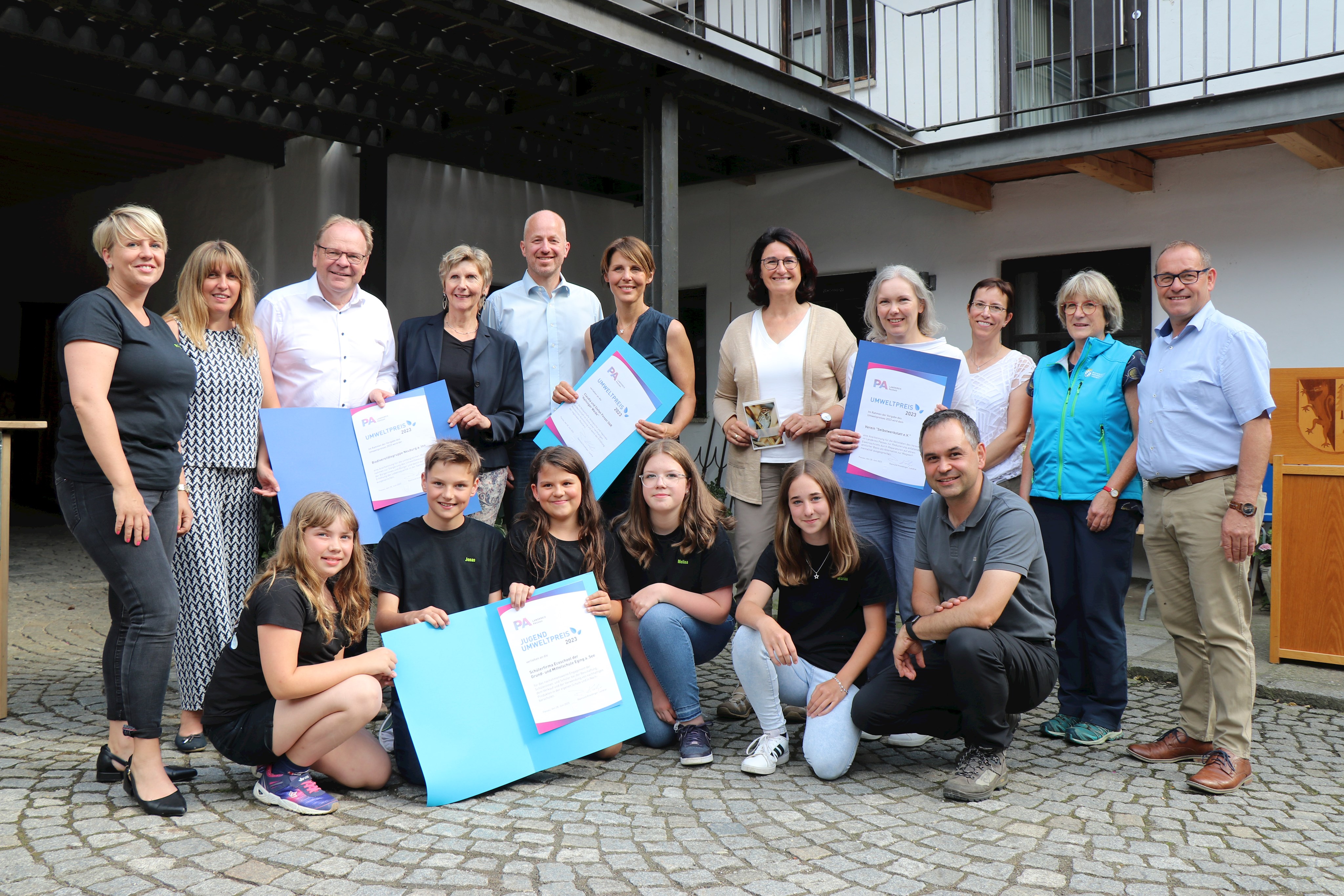 Lehrerin Simone Rauch (ecoschool hinten, v.l.), Nicole List, Bürgermeister Wolfgang Lindmeier, Dorothee Hartmann (alle drei Arbeitsgruppe Biodiversität Neuburg am Inn), Stefan und Claudia Fenzel, Regina Krieger, Karin Polz (Selbstwerkstatt Pocking), Susanne Bloch (Abteilungsleiterin), Christiane Kotz (Naturschutzreferentin), Bürgermeister Christian Fürst, Alina Stockmeier (vorne v.l.), Jonas Drexler, Elli Ranzinger, Melina Fries, Marina Duschl (alle ecoschool) und Landrat Raimund Kneidinger.